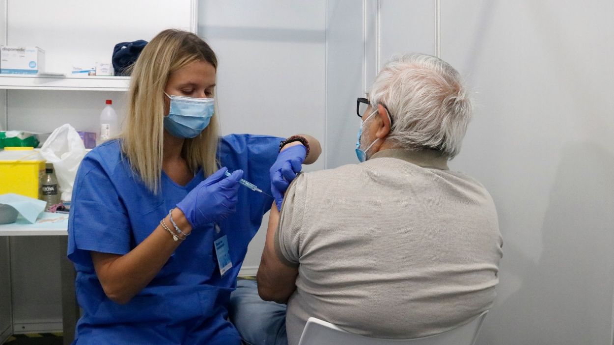 Una infermera vacuna un home al punt de vacunació massiva de Fira de Barcelona / Foto: Blanca Blay - ACN