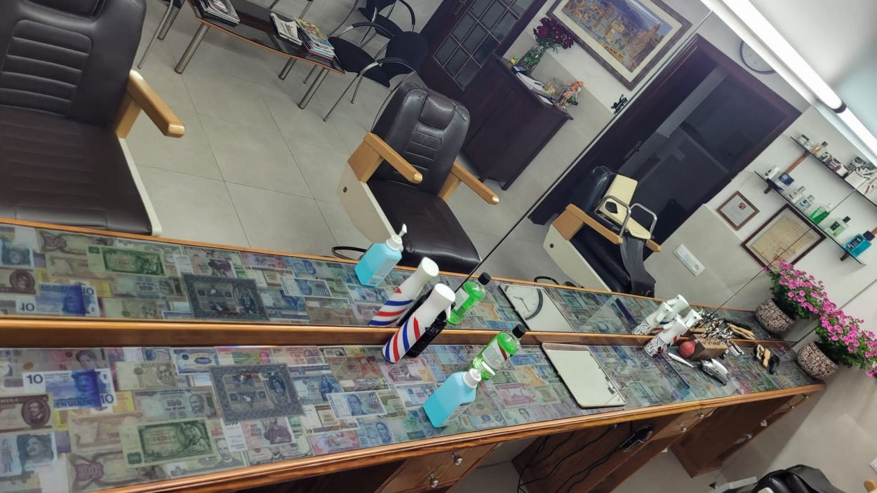 Exposició de la col·lecció de bitllets al taulell de la Perruqueria Joan Llongueras
