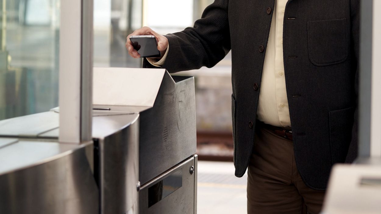 Un usuari del transport pblic utilitzant el seu dispositiu mbil per entrar al tren / Foto: ACN (Cedida per ATM)